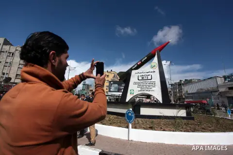 A Palestinian man takes a pictures of the mobile phones for a model of homemade M75 rocket in the middle of a square in Gaza City. Hamas fired M75 rockets at Tel Aviv and Jerusalem in the 2012 eight-day fighting with Isr...
