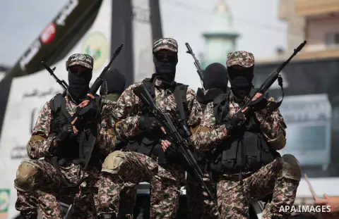 Palestinian Hamas militants carrying weapons ride on a vehicle during an anti-Israel parade in Gaza City March 10, 2014. Israel on 05 March had intercepted a cargo vessel in the Red Sea carrying dozens of advanced rocket...