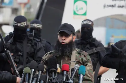 Palestinian member of al-Qassam Brigade, the military wing of Hamas movement, Nasman Hammam holds a press conference in Gaza City on March 10, 2014. Hamas fired M75 rockets at Tel Aviv and Jerusalem in the 2012 eight-day...
