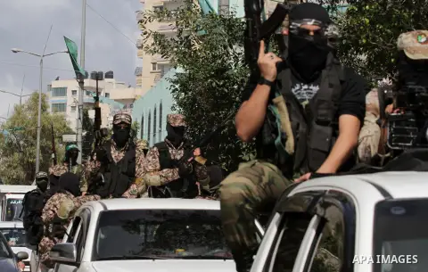 Palestinian Hamas militants carrying weapons ride on a vehicle during an anti-Israel parade in Gaza City March 10, 2014. Israel on 05 March had intercepted a cargo vessel in the Red Sea carrying dozens of advanced rocket...