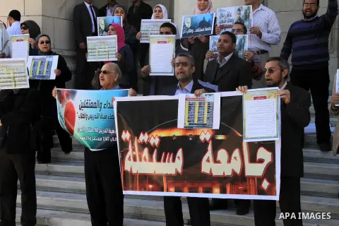 Egyptian students of the faculty of Pharmacy in the Cairo University hold placards during a demonstration calling for the release of their colleagues detained by the army-backed interim authorities, in Cairo March 10, 20...