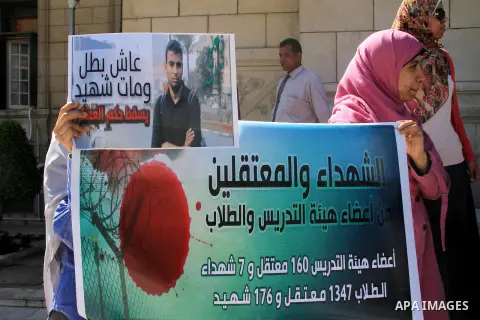 Egyptian students of the faculty of Pharmacy in the Cairo University hold placards during a demonstration calling for the release of their colleagues detained by the army-backed interim authorities, in Cairo March 10, 20...