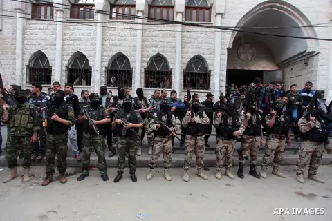 Islamic jihad militants take part in the funeral of three comrades, who were killed in an Israeli air strike, in Khan Younis in the southern Gaza Strip March 11, 2014. An Israeli air strike on Tuesday killed three Palest...