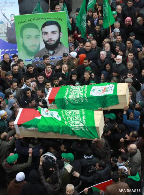 Palestinian Hamas supporters carry the coffins said to contain the remains of Hamas militants Maher Ihbeshe and Imad Zubede, who were both killed 13 years ago, during their funeral in the West Bank City of Nablus, 12 Mar...