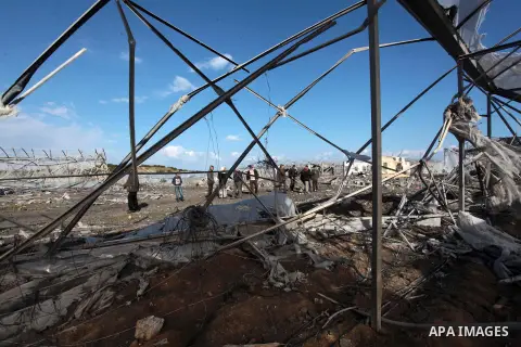 Palestinians inspect the scene of an Israeli air strike in Rafah in the southern of Gaza Strip March 14, 2014. A small armed faction in the Gaza Strip fired rockets at Israel on Thursday, drawing retaliatory air strikes...