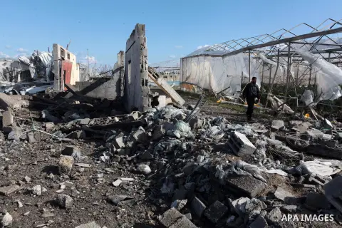 A Palestinian man inspects the scene of an Israeli air strike in Rafah in the southern of Gaza Strip March 14, 2014. A small armed faction in the Gaza Strip fired rockets at Israel on Thursday, drawing retaliatory air st...