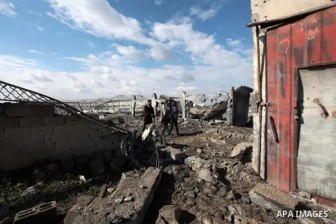 Palestinians inspect the scene of an Israeli air strike in Rafah in the southern of Gaza Strip March 14, 2014. A small armed faction in the Gaza Strip fired rockets at Israel on Thursday, drawing retaliatory air strikes...