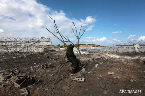 A Palestinian man inspects the scene of an Israeli air strike in Rafah in the southern of Gaza Strip March 14, 2014. A small armed faction in the Gaza Strip fired rockets at Israel on Thursday, drawing retaliatory air st...
