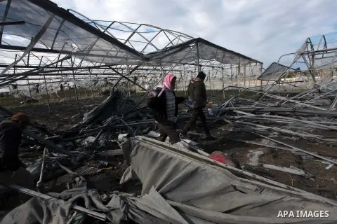 Palestinians inspect the scene of an Israeli air strike in Rafah in the southern of Gaza Strip March 14, 2014. A small armed faction in the Gaza Strip fired rockets at Israel on Thursday, drawing retaliatory air strikes...