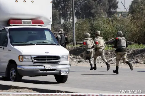 Egyptian soldiers and officials inspect the sight where gunmen killed six soldiers at a Cairo checkpoint on March 15, 2014 in an attack the military blamed on the Muslim Brotherhood movement of deposed president Mohamed...