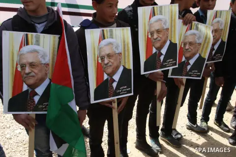 Palestinian Fatah supporters hold placards showing pictures of President Mahmoud Abbas during a rally in support of Abbas in the West Bank village of Tubas near Jenin March 16, 2014. With pessimism growing over future of...
