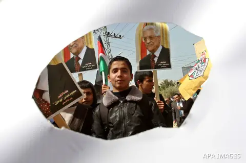 Palestinian Fatah supporters hold placards showing pictures of President Mahmoud Abbas during a rally in support of Abbas in the West Bank village of Tubas near Jenin March 16, 2014. With pessimism growing over future of...