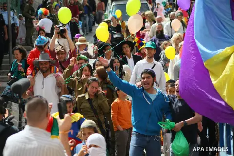 Dressed up Israelis take part in a parade to celebrate the Jewish holiday of Purim in al-Shuhada street, in the West Bank town of Hebron, on March 16, 2014. The carnival-like Purim holiday is celebrated with parades and...