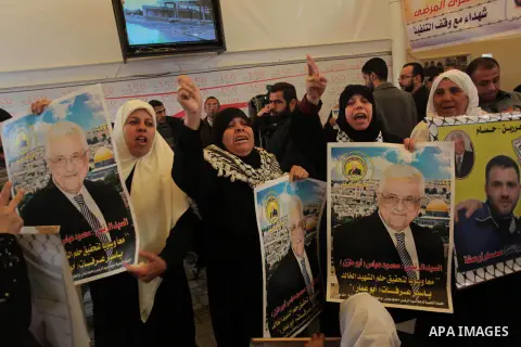 Palestinian women hold placards showing pictures of President Mahmoud Abbas during a protest demanding the release of their relatives prisoners held in Israeli jails, in front of the Red Cross office in Gaza City, on Mar...