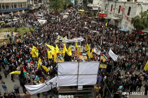 Palestinian Fatah supporters hold Palestine flags and posters of Palestinian President Mahmoud Abbas during a support rally in West Bank City of Nablus, 17 March 2014. Thousands of Palestinians in several cities in the W...