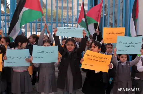 Palestinian children take part in a protest against the decision made by the United Nations Relief and Works Agency (UNRWA) to reduce food aid delivered to the Gaza Strip in front of the UNRWA headquarters in Gaza City o...