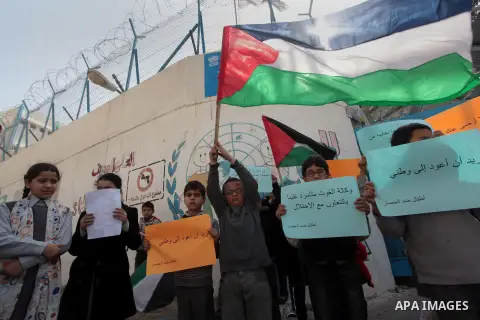 Palestinian children take part in a protest against the decision made by the United Nations Relief and Works Agency (UNRWA) to reduce food aid delivered to the Gaza Strip in front of the UNRWA headquarters in Gaza City o...