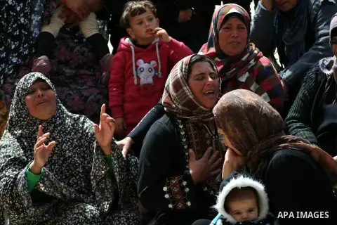Relatives of Palestinian teenager Yussef Shawamreh mourn outside his house in the West Bank village of Deir al-Asal, 15 kilometres from Hebron on March 19, 2014 after he was shot by Israeli troops in the occupied West Ba...