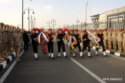 Egyptian security guards carry the bodies of two army officers killed by a militant group, during their funeral in Cairo on March 19, 2014. Two Egyptian army officers were killed on Wednesday during a raid on militant hi...