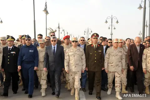 A handout picture released by the military moral affairs shows the Egypt's army chief, Field Marshal Abdel Fattah al-Sisi, attends the funeral of two army officers killed by a militant group, in Cairo on March 19, 2014....