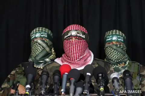 Palestinian militants of the Hamas' armed wing, Ezzeddine al-Qassam Brigades, attend a press conference in Gaza City, March 20, 2014. A tunnel that was uncovered by the IDF between Gaza Strip and Israel was destroyed twi...