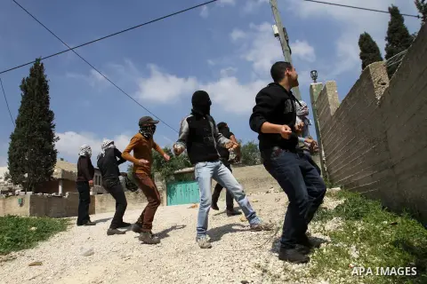 Palestinian protesters throw stones at Israeli security forces following a weekly protest against the expropriation of Palestinian land by Israel in the village of Kfar Qaddum, near Nablus, in the occupied West Bank on M...
