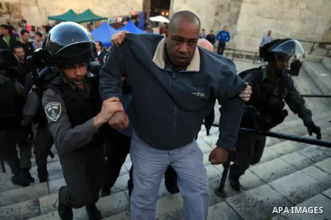 A Palestinian is arrested by Israeli security forces on March 22, 2014 at Jerusalem's Damascus Gate leading into the Old City during clashes following a protest against the killing of three Palestinians were killed in Je...
