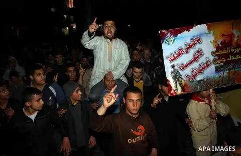 Palestinian supporters of Hamas and Jihad Islamic movements chant slogans during a protest in Gaza City on March 22, 2014 against the killing of three Palestinians were killed in Jenin refugee camp in the West Bank durin...