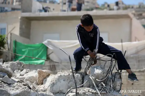 A Palestinian boy sits on the rubble after Israeli forces destroyed his family house in Khallat al-Ein square in the al-Tur neighborhood east of the Old City of Jerusalem, on March 26, 2014. Israel rarely grants Palestin...