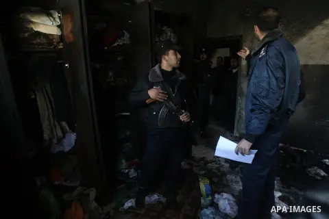 Palestinian policemen inspect the damage in the room after a fire swept over a house in Rafah sothern in Gaza city on March 27, 2014. Gaza residents often use candles to light their house during frequent power cuts, whic...