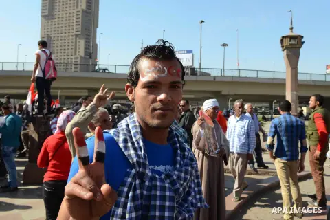 Egyptian supporter of Former Egyptian military chief and presidential candidate Abdel-Fattah el-Sisi, hold his pictures during a rally to support him in Cairo on March 28, 2014. Al-Sisi announced on Wednesday his preside...
