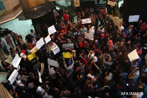 Egyptian journalists hold banners during a protest the death of the Egyptian journalist Mayada Ashraf, outside the Egyptian Journalist Syndicate in Cairo, on March 29, 2014. Al-Dustour, a privately-owned newspaper, said...