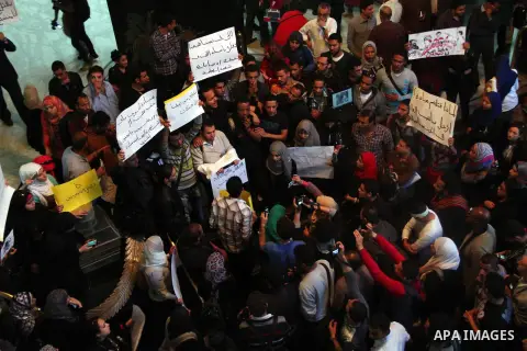 Egyptian journalists hold banners during a protest the death of the Egyptian journalist Mayada Ashraf, outside the Egyptian Journalist Syndicate in Cairo, on March 29, 2014. Al-Dustour, a privately-owned newspaper, said...