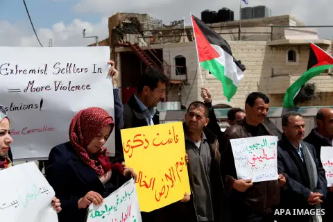 Palestinians protest near an Israeli-occupied Palestinian home, located close to the Kiryat Arbaa Jewish settlment, as Palestinians across the Israeli occupied West Bank and the Gaza Strip commemorate Land Day on March 3...