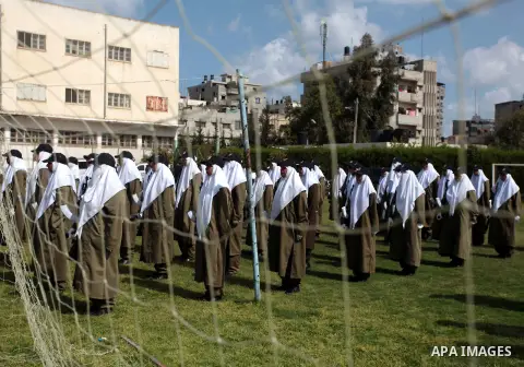 Female members of Palestinian security forces stand during a military graduation ceremony in Gaza City on April 02, 2014. Photo by Ashraf Amra