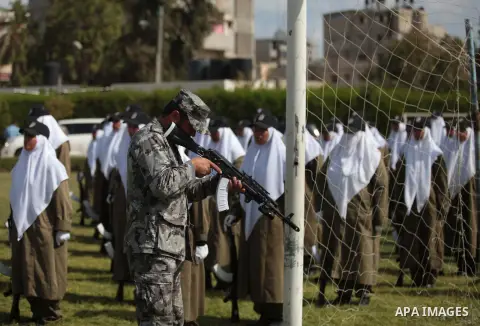 Female members of Palestinian security forces stand during a military graduation ceremony in Gaza City on April 02, 2014. Photo by Ashraf Amra