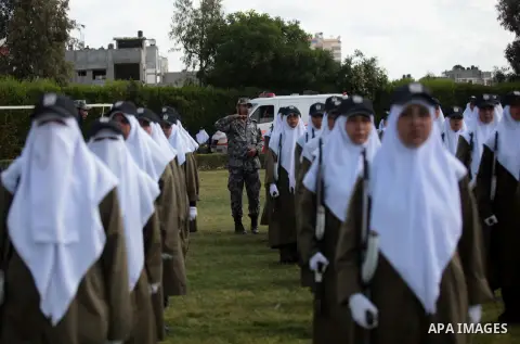 Female members of Palestinian security forces stand during a military graduation ceremony in Gaza City on April 02, 2014. Photo by Ashraf Amra