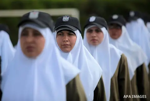 Female members of Palestinian security forces stand during a military graduation ceremony in Gaza City on April 02, 2014. Photo by Ashraf Amra