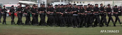 Palestinian members of security forces stand during a military graduation ceremony in Gaza City on April 02, 2014. Photo by Ashraf Amra