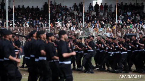 Palestinian members of security forces stand during a military graduation ceremony in Gaza City on April 02, 2014. Photo by Ashraf Amra