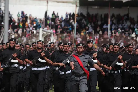 Palestinian members of security forces stand during a military graduation ceremony in Gaza City on April 02, 2014. Photo by Ashraf Amra