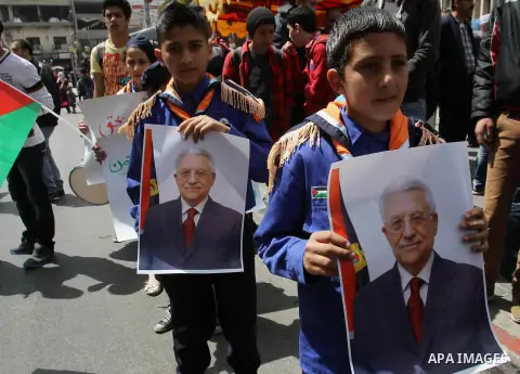 Palestinian scouts hold posters of Palestinian President Mahmoud Abbas during a Fatah rally in support of Abbas in the West Bank city of Nablus April 2, 2014. Abbas said he had begun steps to join several UN agencies, ab...