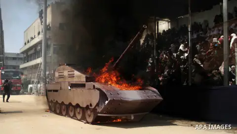 A picture shows burn a tank during a military graduation ceremony in Gaza City on April 02, 2014. 1200 officers graduated from advanced training courses that lasted one year in Gaza police academy. Photo by Ashraf Amra