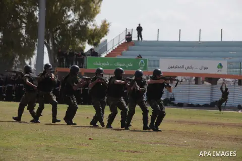 Palestinian members of security forces stand during a military graduation ceremony in Gaza City on April 02, 2014. 1200 officers graduated from advanced training courses that lasted one year in Gaza police academy. Photo...