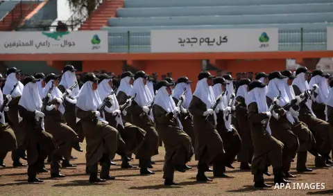 Female members of Palestinian security forces stand during a military graduation ceremony in Gaza City on April 02, 2014. 1200 officers graduated from advanced training courses that lasted one year in Gaza police academy...