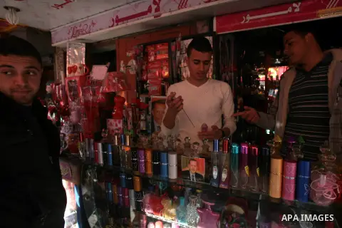 A Palestinian vendor blends perfume in bottles called "Erdogan" at his shop in Rafah in the southern Gaza Strip, April 03, 2014. Palestinian Prime Minister in Gaza Strip Ismail Haniyeh said Wednesday that his Turkish cou...