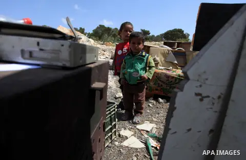 Palestinian Bedouin children stand amid the rubble of tents and sheds demolished by the Israeli army in Al-Azariya, on the outskirts of Jerusalem, on April 3, 2014, on the grounds that it was built without a construction...