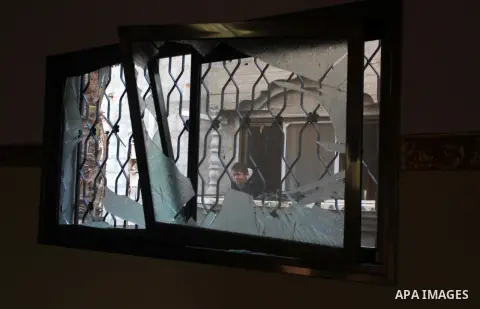 A Palestinian boy is seen through a damaged house window following an overnight Israeli air strike on a nearby land in the central Gaza Strip April 4, 2014. After Israel called off the planned release of 26 Palestinian p...