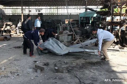 Palestinians inspect a cars workshop following an overnight Israeli air strike on Jabalia in the northern Gaza Strip, on April 4, 2014. After Israel called off the planned release of 26 Palestinian prisoners the day befo...