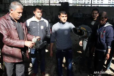 Palestinians hold the remains of an Israeli rocket following an overnight Israeli air strike on Jabalia in the northern Gaza Strip, on April 4, 2014. After Israel called off the planned release of 26 Palestinian prisoner...